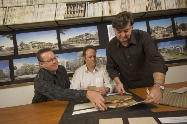 Three architects busy checking designs
