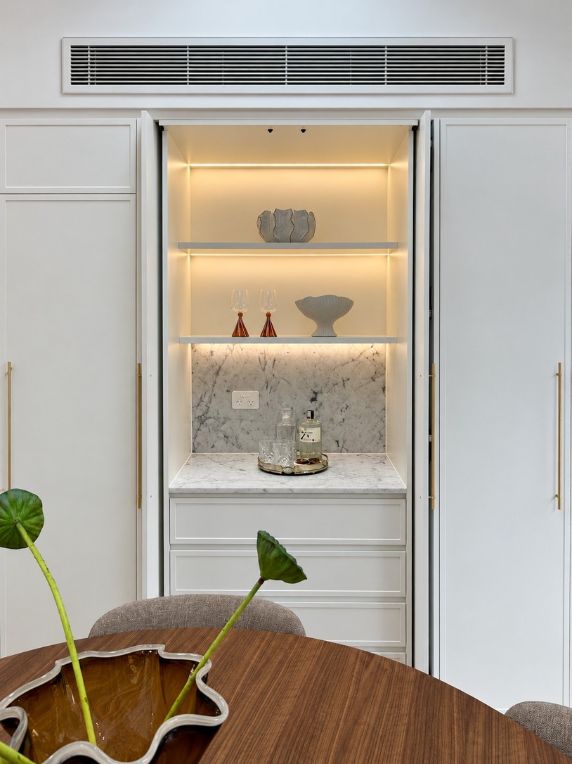 Built-in bar cabinet with lit shelving, part of the extensive joinery in a Paddington terrace