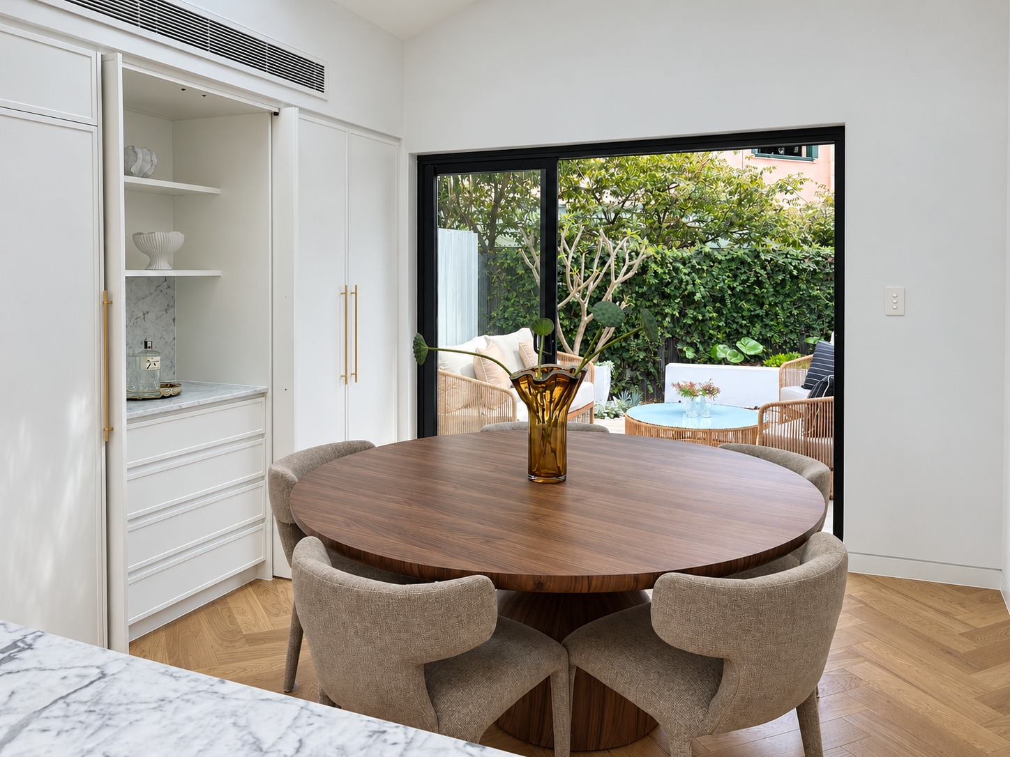 Dining area opening to the courtyard, part of the reconfigured terrace house design